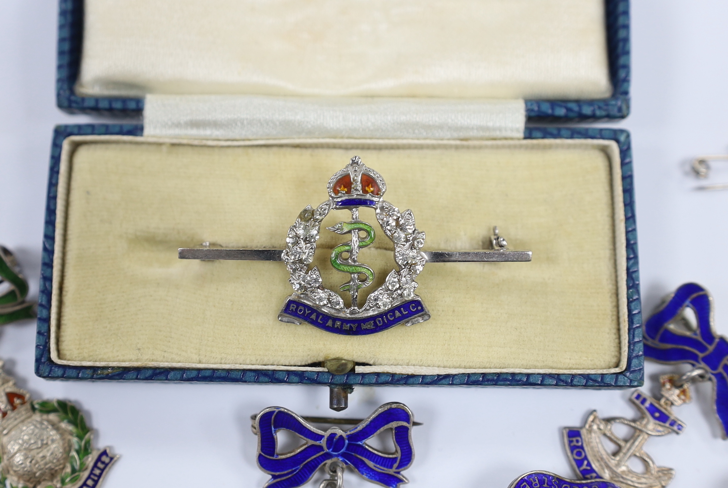Seven white metal etc. enamelled sweetheart and related brooches, examples including; RAF, Royal Navy, RAMC, Royal Marines, etc.